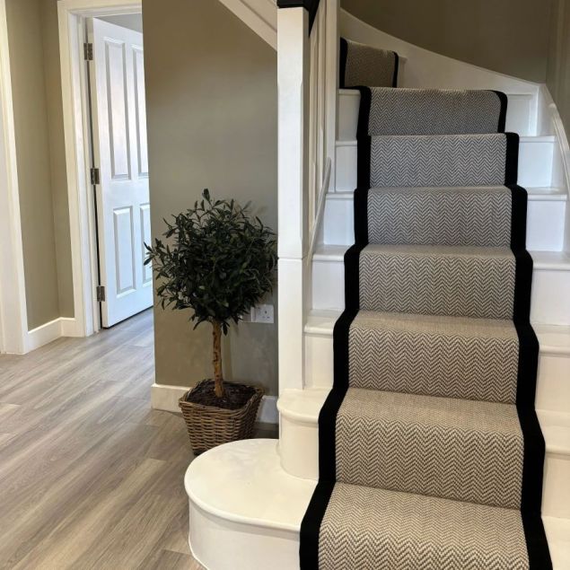 Flatweave Herringbone Carpet in Dapple on stairs in neutral hallway